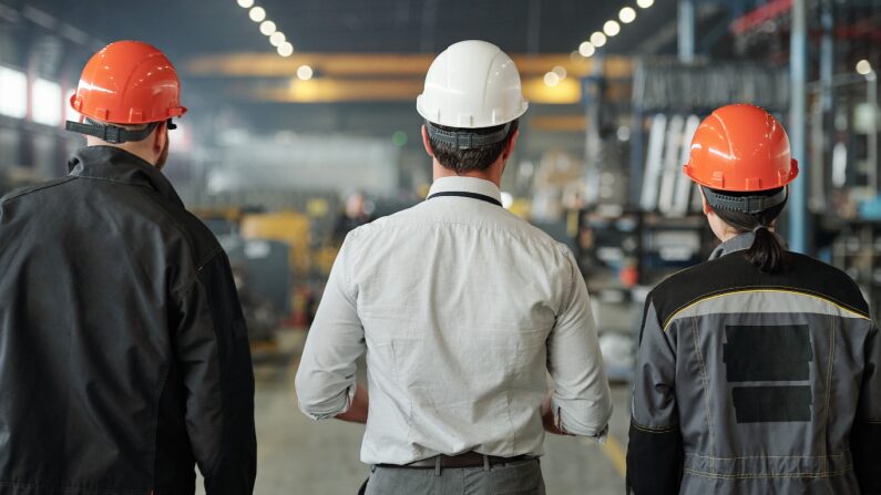 Industrial manufacturing team reviewing production operations